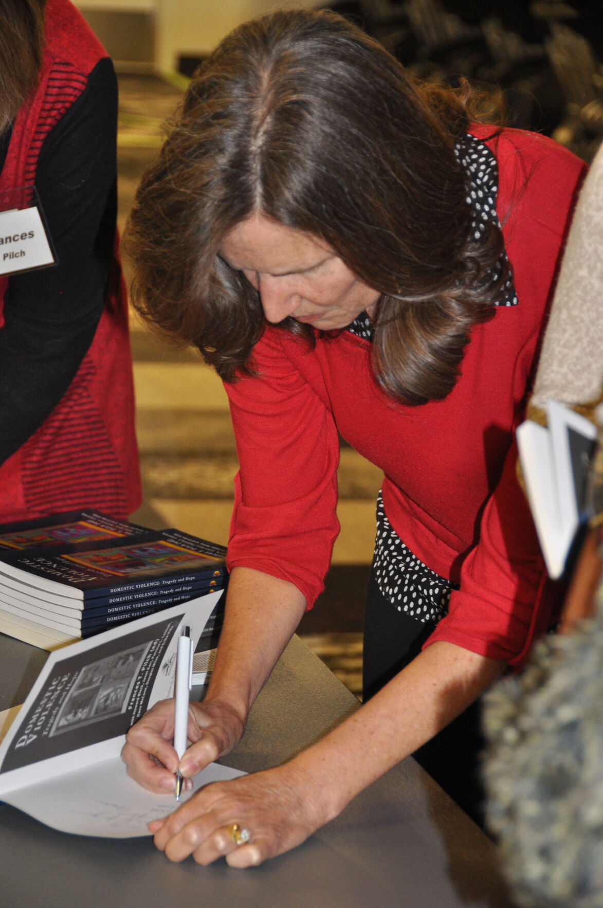 Kerr signs the book.JPG